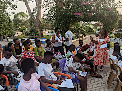 School girls listening to instructors Alberta Klokpa and Mawuse Edith Nyakpo