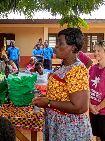 Headmistress Emmiline Nyakey accepts the donations on behalf of the school