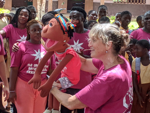 Kirsten Sixt presents puppets to the school