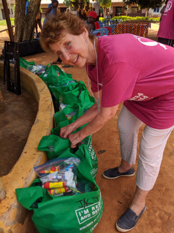 Patricia Tyson, one of 20 Canadians who donated school supplies, inspects the contents of the donation bags before the presentation